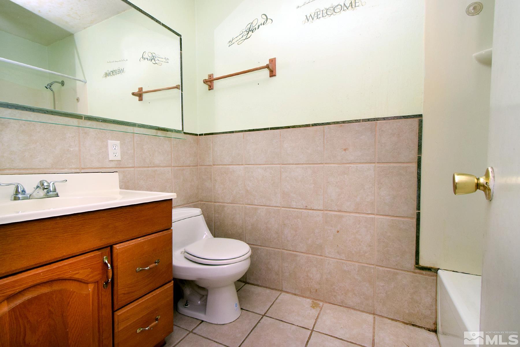 1279 Ebbetts Drive Reno, NV 89503 - Photo 23 of 37 a bathroom with a sink a toilet and a mirror