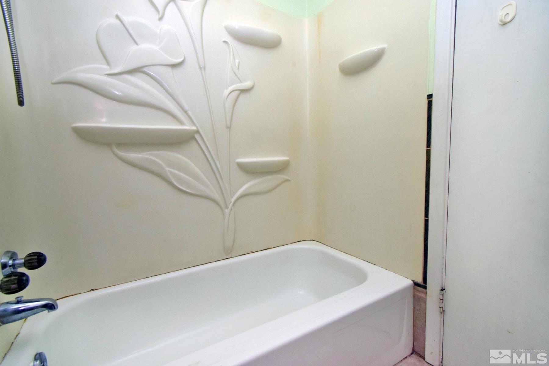 1279 Ebbetts Drive Reno, NV 89503 - Photo 24 of 37 a bathroom with a white bath tub and a shower curtain