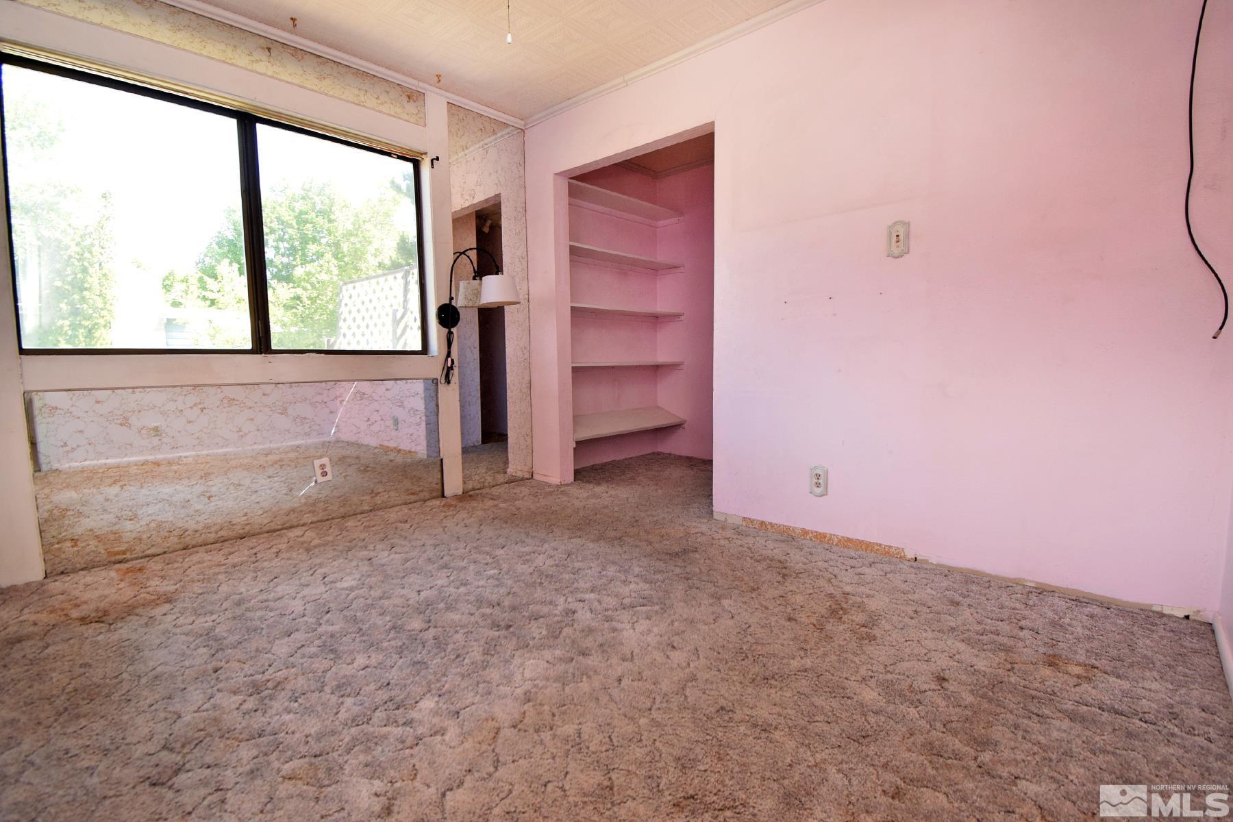 1279 Ebbetts Drive Reno, NV 89503 - Photo 25 of 37 a view of empty room with a fireplace and windows