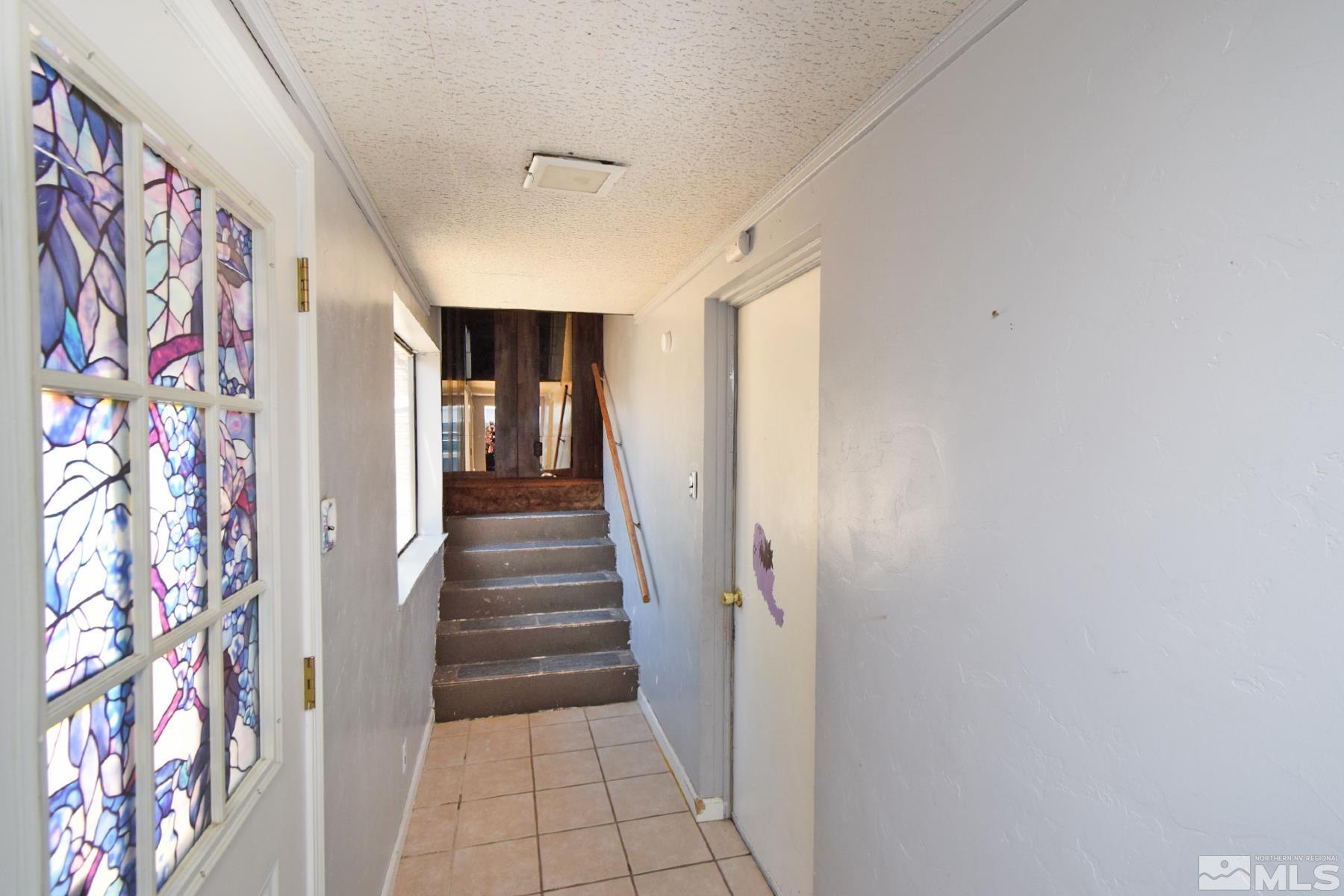 1279 Ebbetts Drive Reno, NV 89503 - Photo 29 of 37 a view of a hallway with entryway and stairs