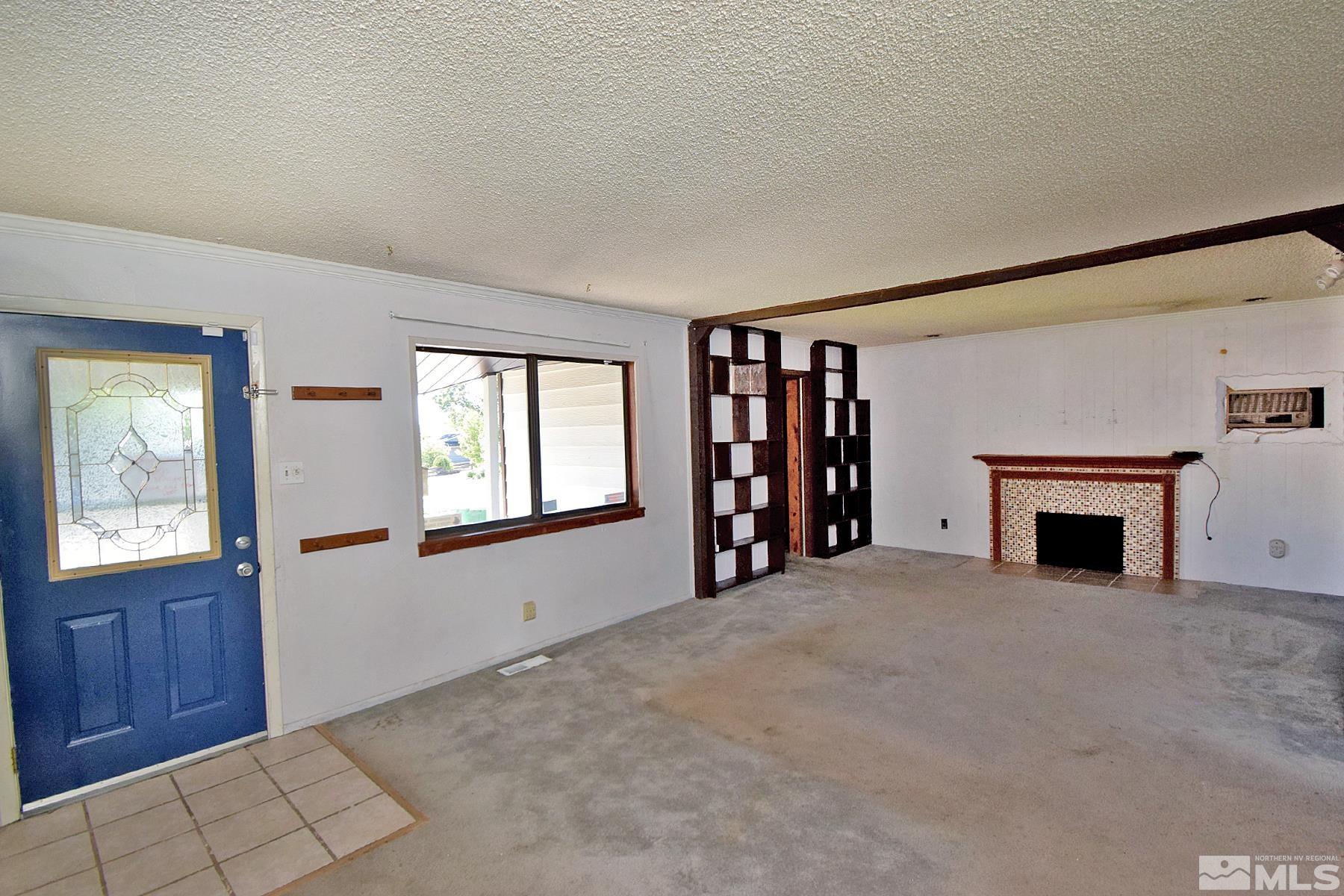 1279 Ebbetts Drive Reno, NV 89503 - Photo 5 of 37 a view of an empty room with a window and fireplace