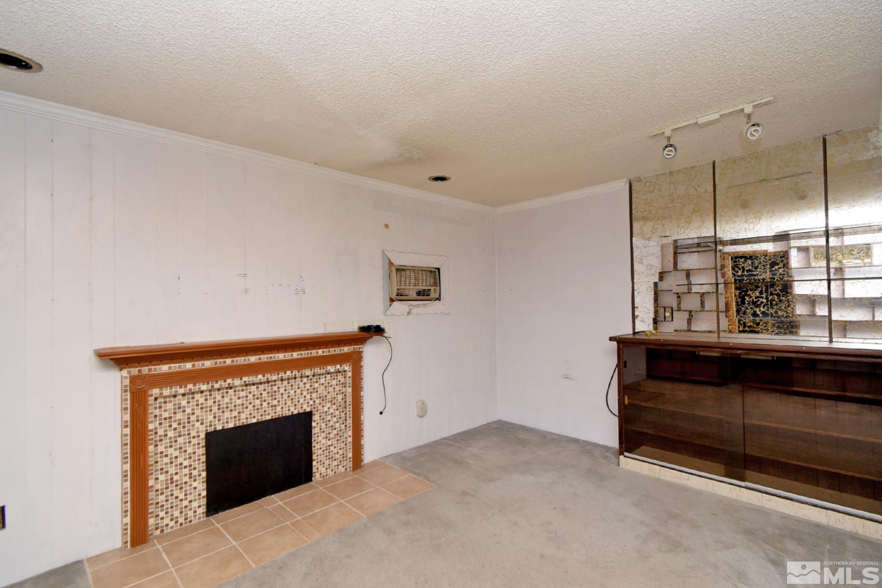 1279 Ebbetts Drive Reno, NV 89503 - Photo 6 of 37 a view of an empty room with window and fireplace