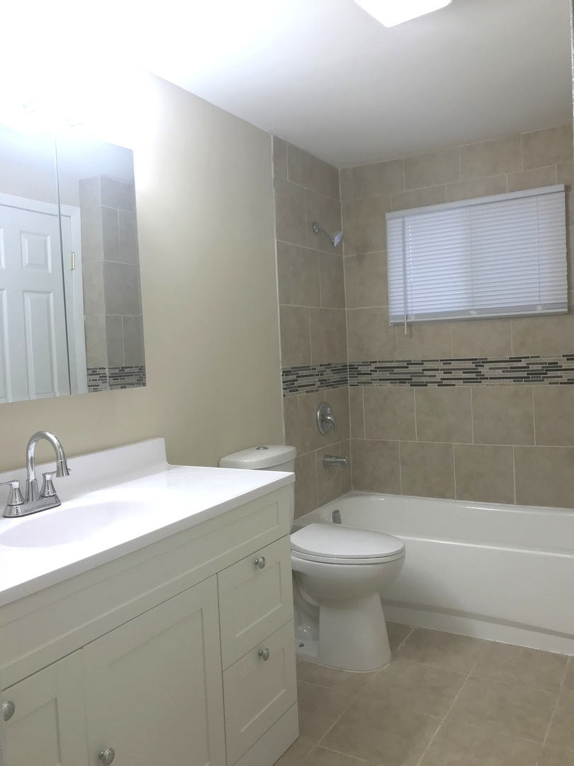 309 Rockhurst Road Bolingbrook, IL 60440 - Photo 11 of 17 a bathroom with a sink a toilet and shower