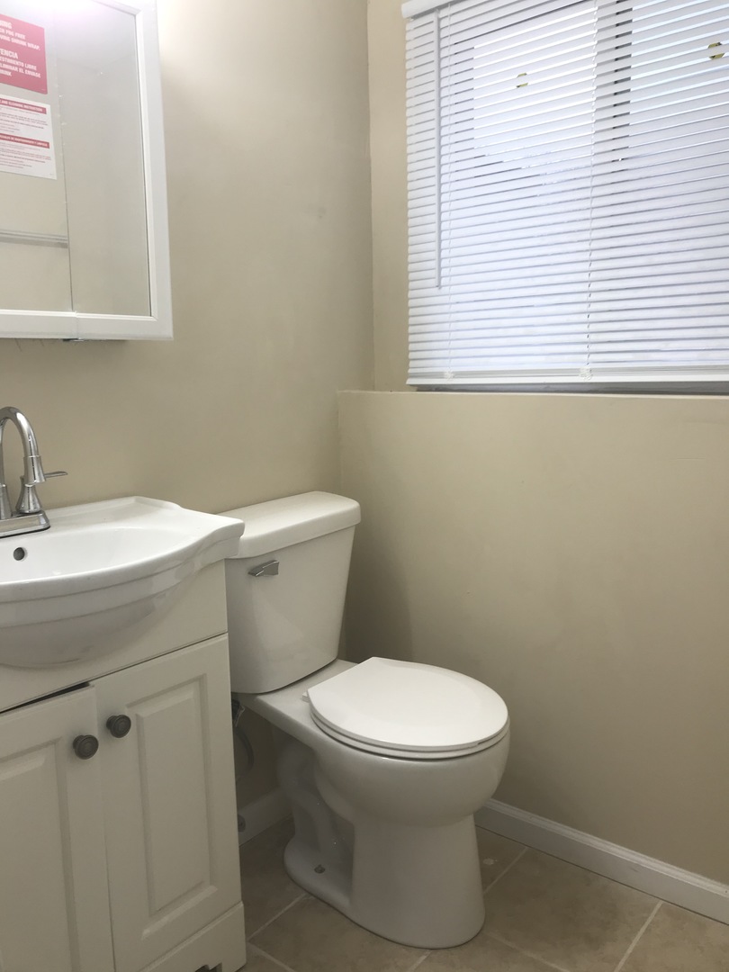 309 Rockhurst Road Bolingbrook, IL 60440 - Photo 16 of 17 a bathroom with a toilet sink and a window