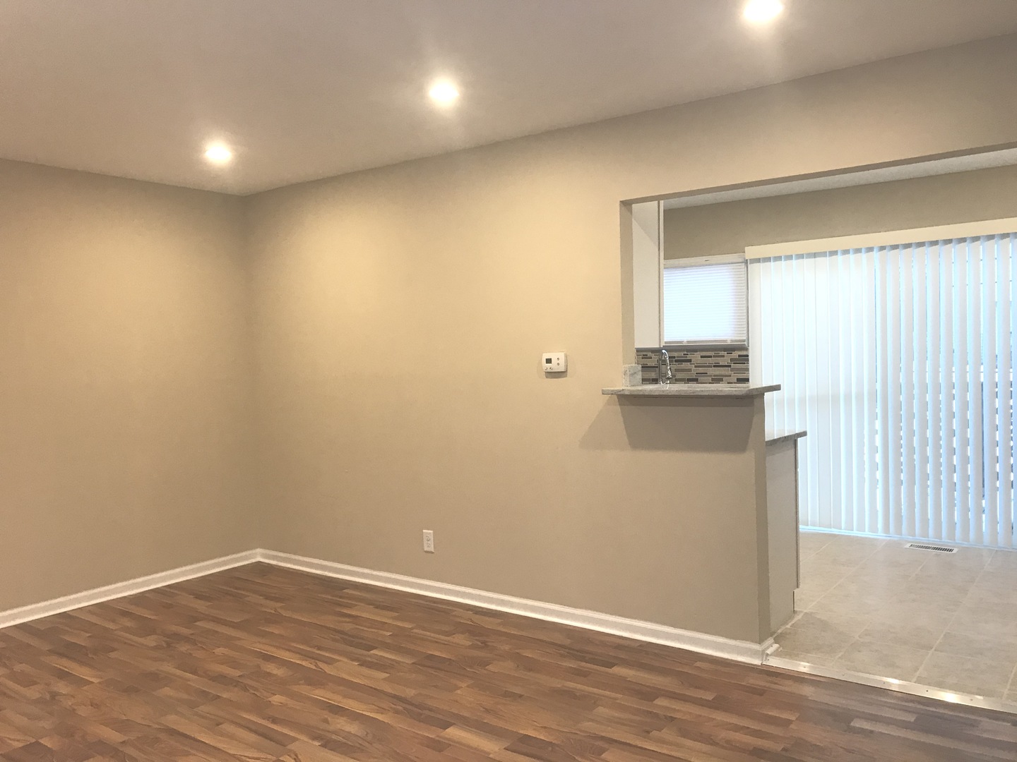 309 Rockhurst Road Bolingbrook, IL 60440 - Photo 3 of 17 an empty room with wooden floor and windows