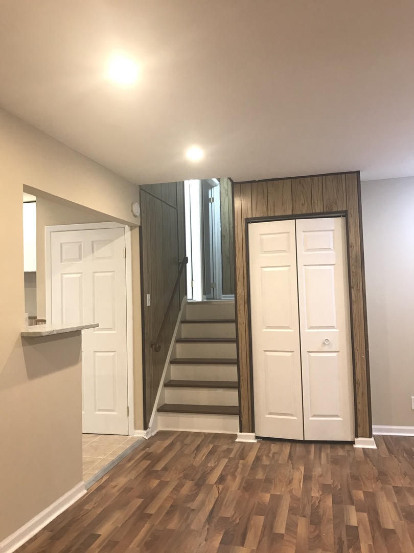 309 Rockhurst Road Bolingbrook, IL 60440 - Photo 4 of 17 a view of a livingroom with wooden floor and stairs