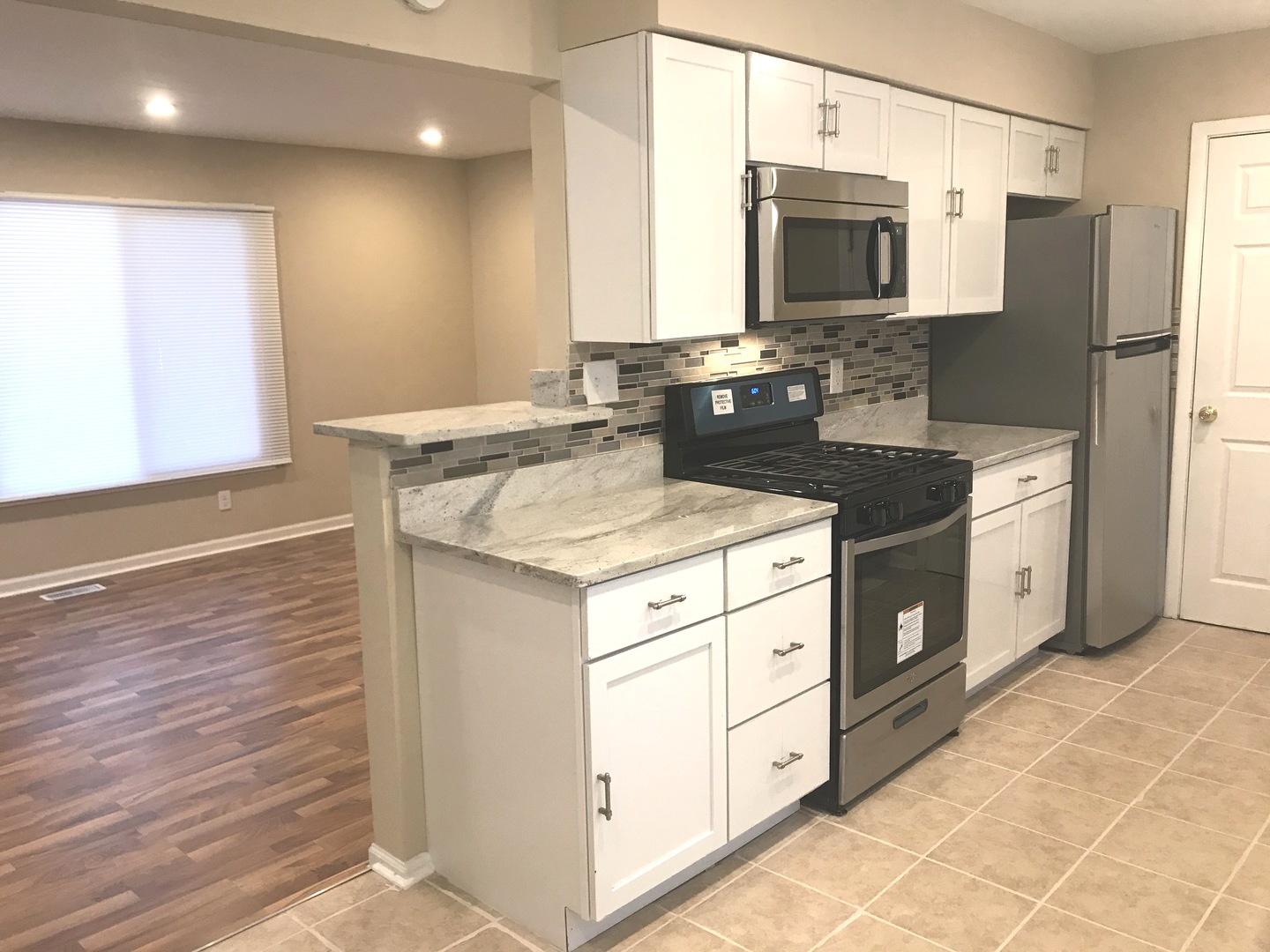 309 Rockhurst Road Bolingbrook, IL 60440 - Photo 5 of 17 a kitchen with stainless steel appliances granite countertop a sink stove and refrigerator