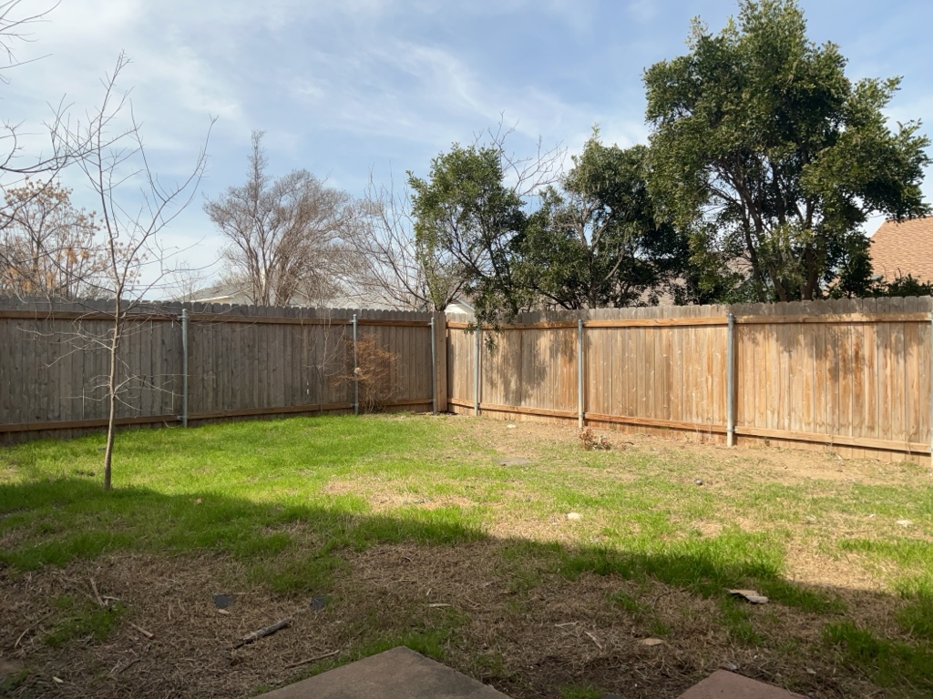 2028 Redwing Way Round Rock, TX 78664 - Photo 22 of 24 a view of a backyard with wooden fence