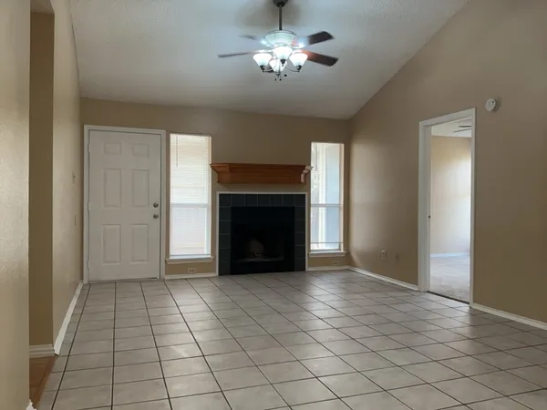 a view of empty room with a fireplace
