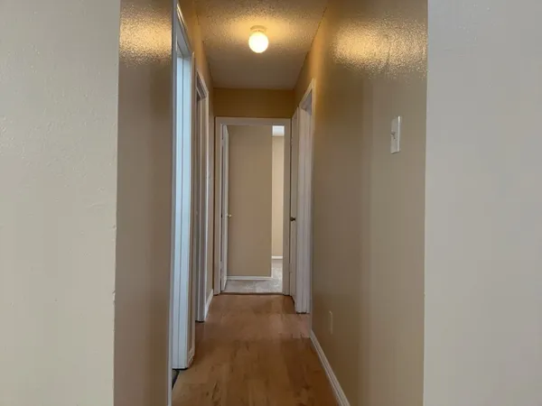 a view of hallway with a bathroom