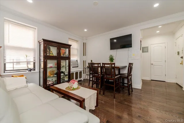 a living room with furniture a window and a flat screen tv