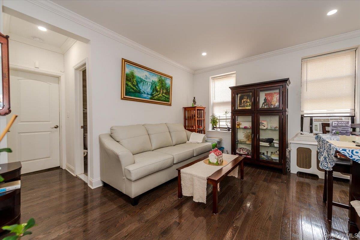 37-21 80th Street, Unit 4H Queens, NY 11372 - Photo 4 of 12 a living room with furniture and wooden floor