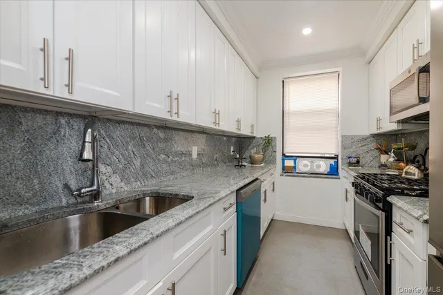 a kitchen with stainless steel appliances granite countertop a sink and a stove