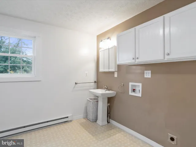 a view of storage and utility room with window