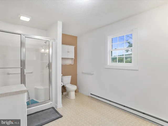 a bathroom with a shower and toilet