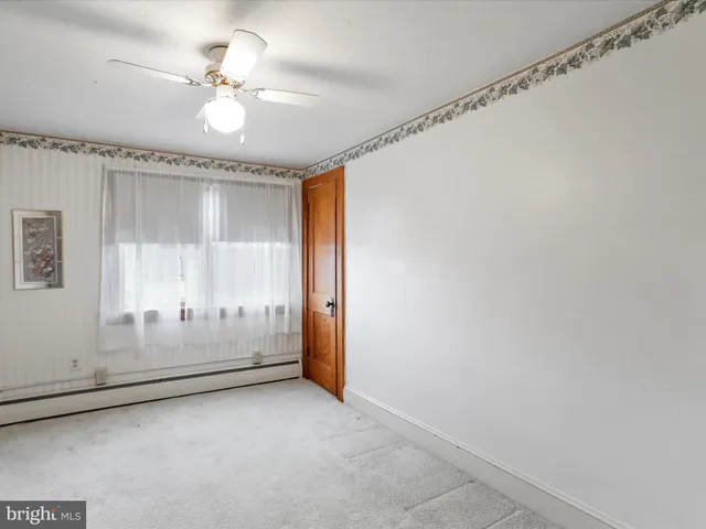 a view of an empty room with a fan