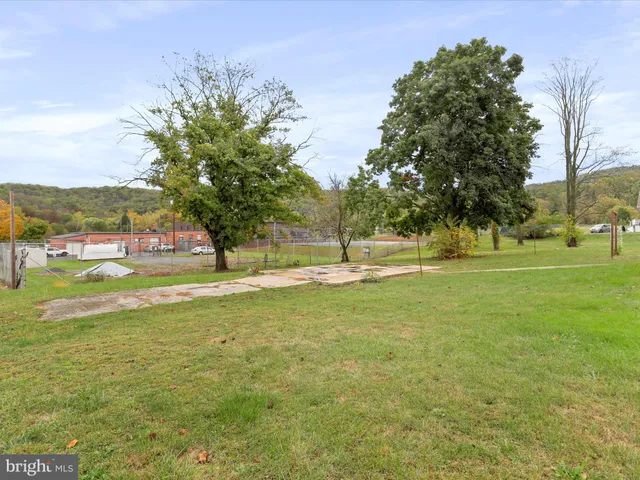 an aerial view of a house with a yard and lake view