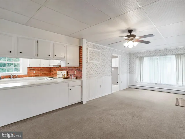 a kitchen with granite countertop a sink stainless steel appliances and cabinets