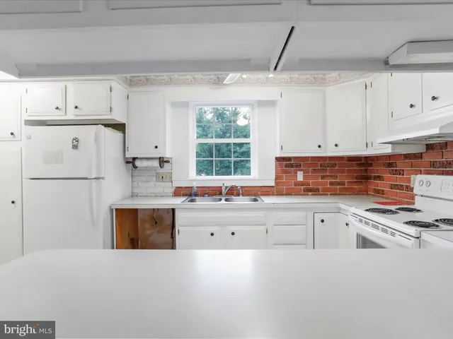 a kitchen with cabinets and window