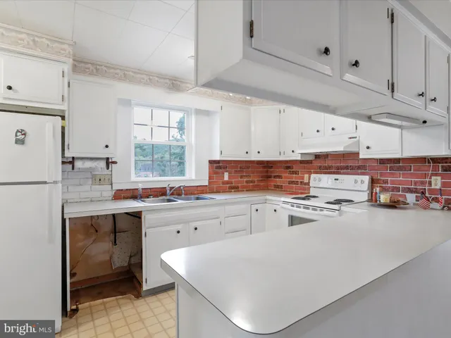 a kitchen with cabinets and window