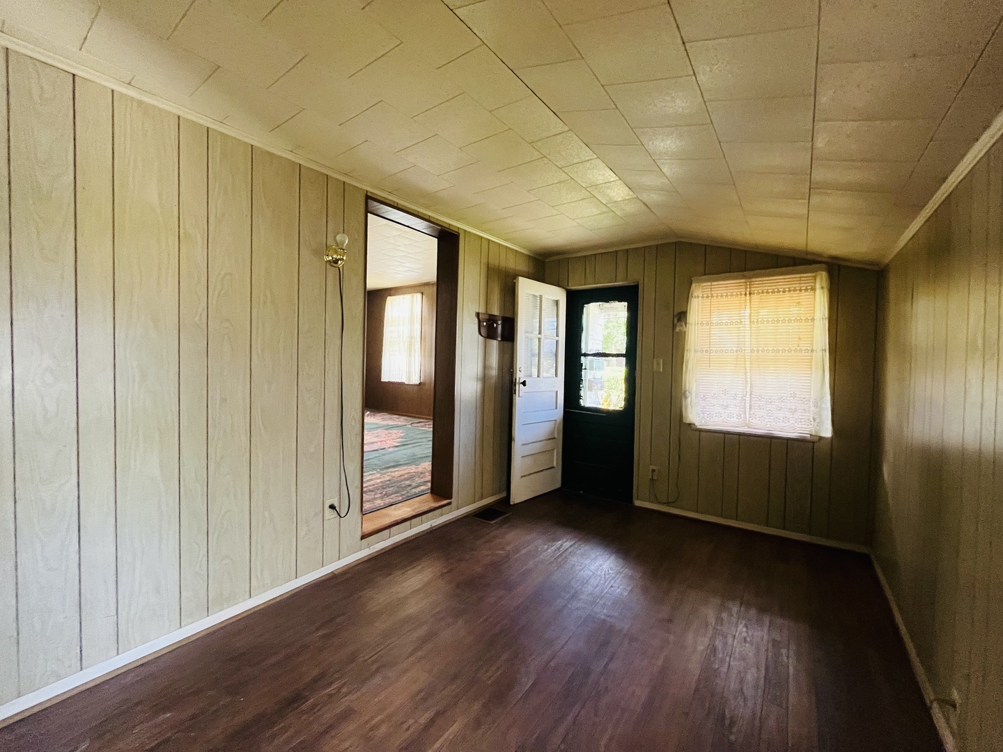 1213 East Main Street Streator, IL 61364 - Photo 12 of 18 a view of an empty room with wooden floor and a window
