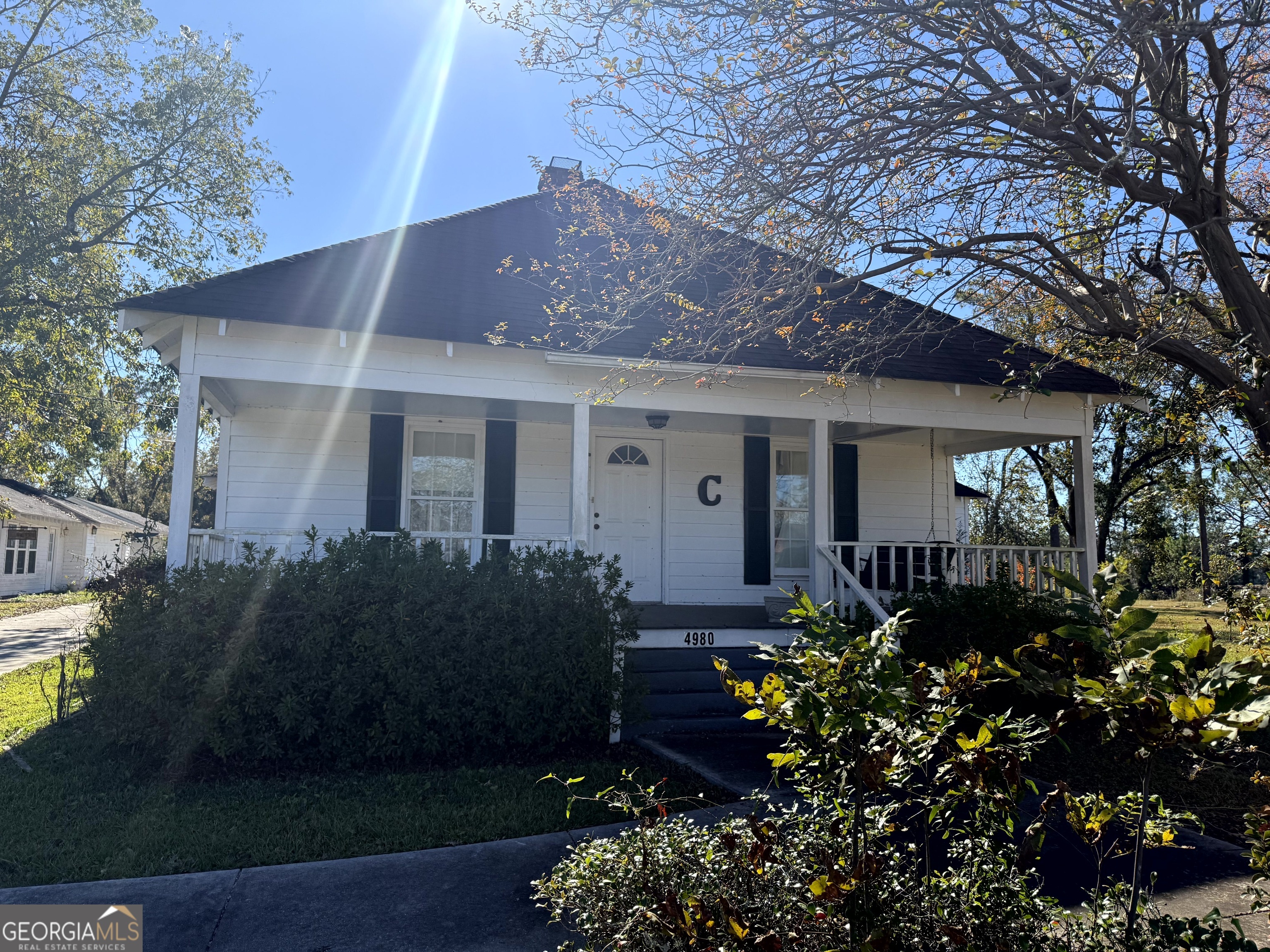 4980 West Broad Street Alston, GA 30410 - Photo 1 of 6 a view of a house with brick walls and a flower garden
