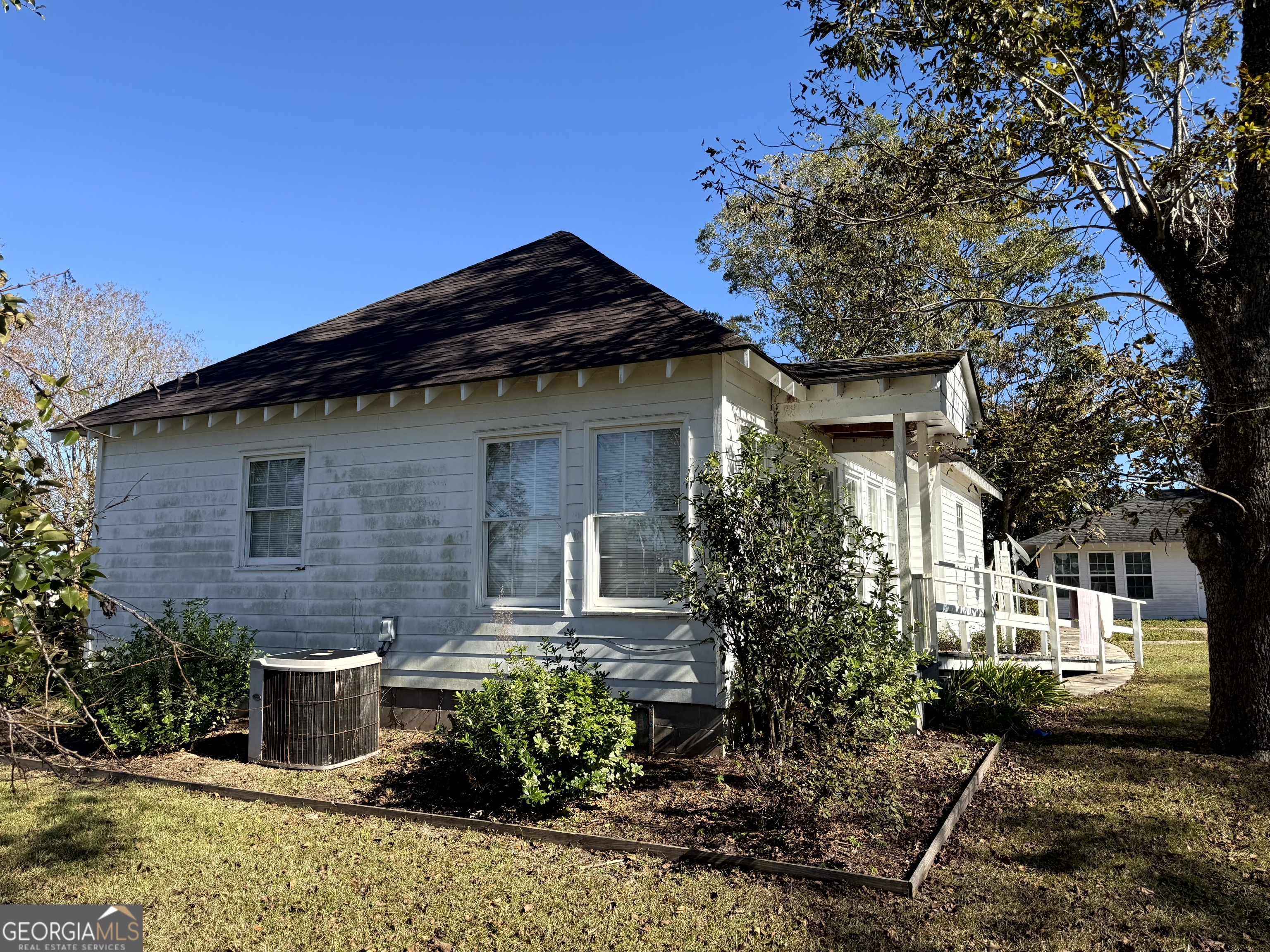4980 West Broad Street Alston, GA 30410 - Photo 2 of 6 a front view of a house with garden