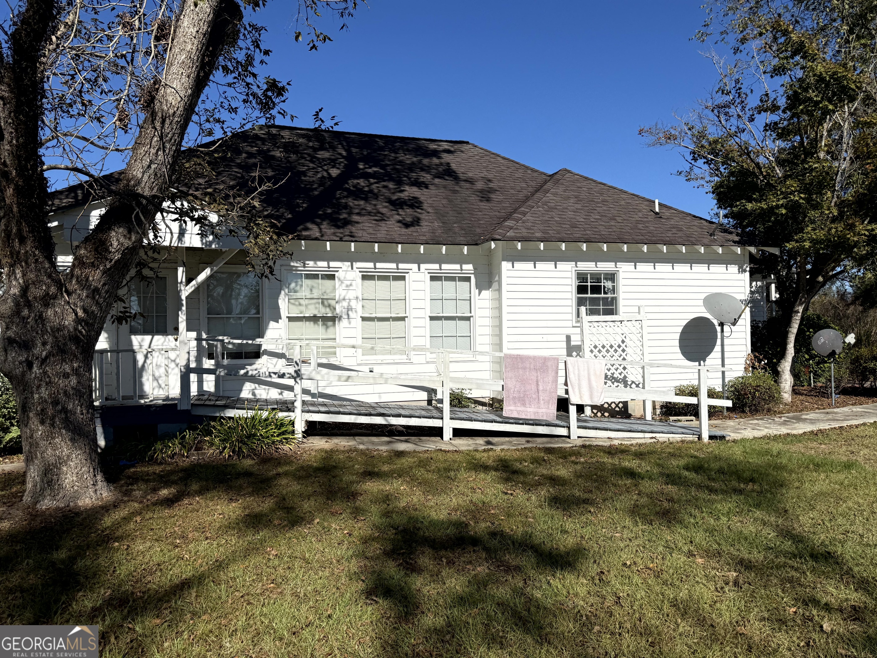 4980 West Broad Street Alston, GA 30410 - Photo 3 of 6 a backyard of a house with table and chairs