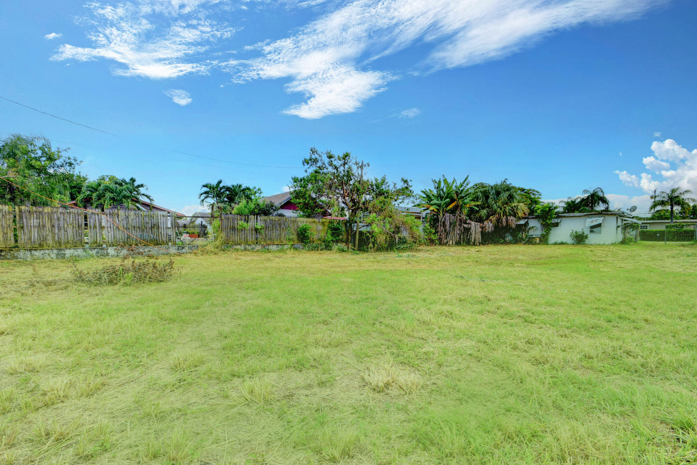 1280 Sunset Road West Palm Beach, FL 33406 - Photo 4 of 5 a view of a garden with a building in the background