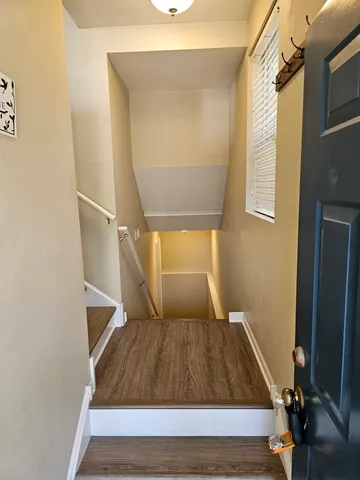 a room with wooden floor and a window