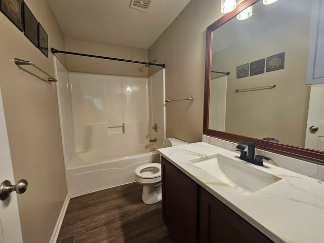 a bathroom with a sink toilet a mirror and shower