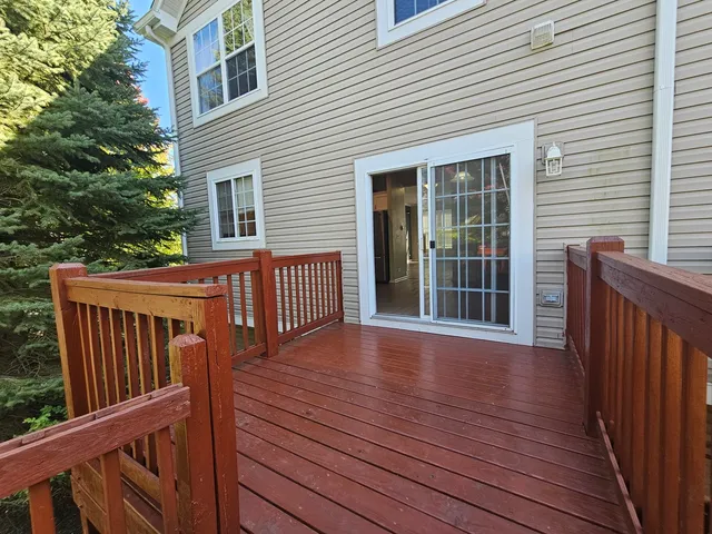 a view of backyard with deck and wooden floor