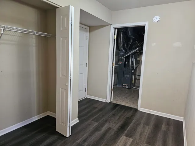 a view of walk in closet with wooden floor