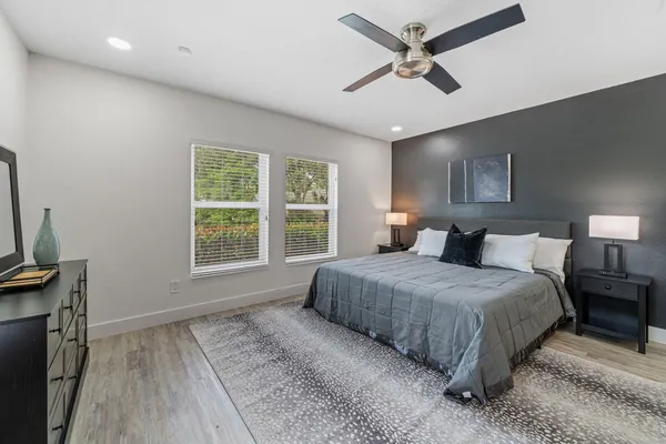 a bedroom with a bed and a flat tv screen