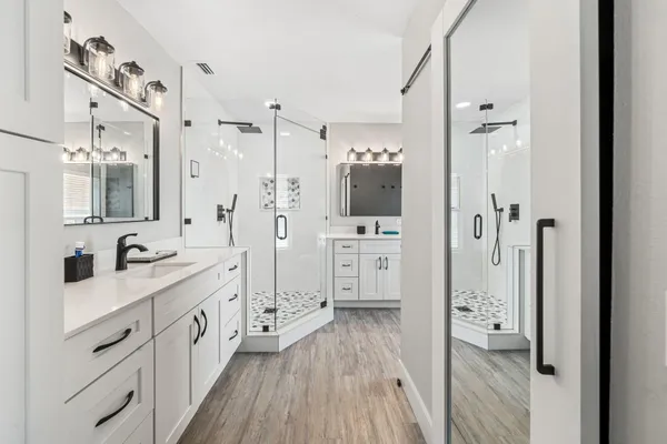 a bathroom with a sink a toilet and shower