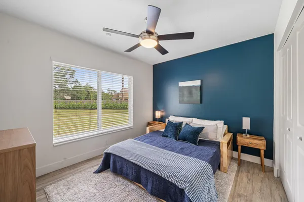 a bedroom with a bed and a window