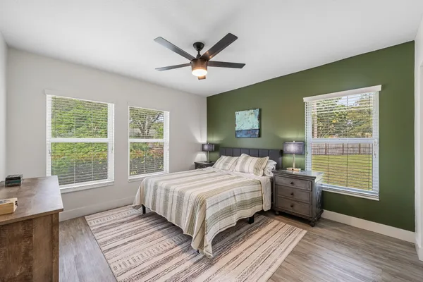a bedroom with a large bed and a window