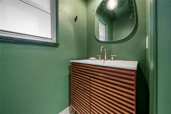 a bathroom with a sink and a mirror