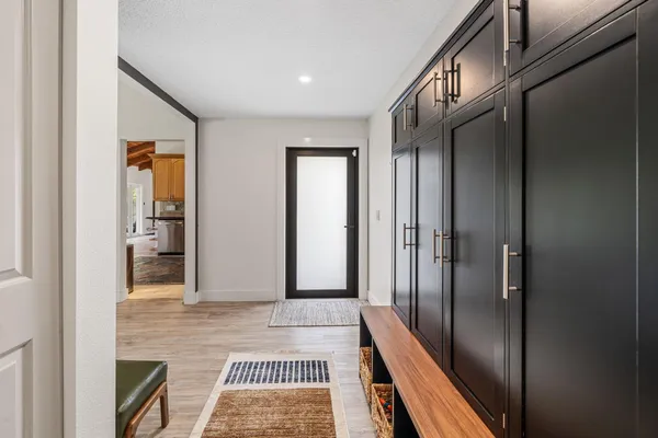 a view of a hallway with wooden floor and staircase