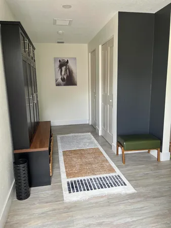a view of a hallway with seating area