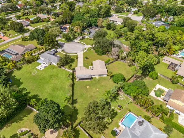 an aerial view of residential houses with yard