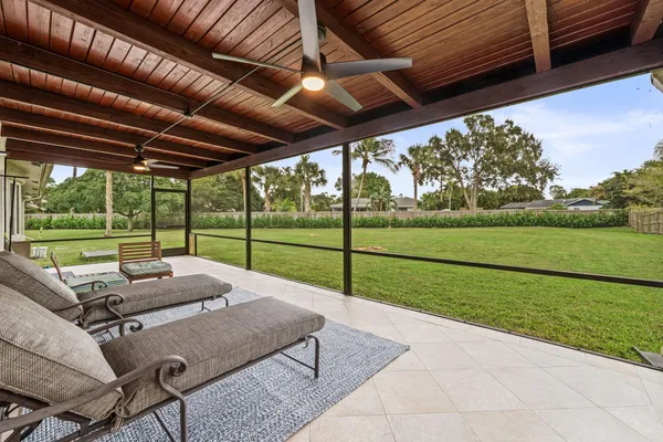 a view of a porch with furniture and garden