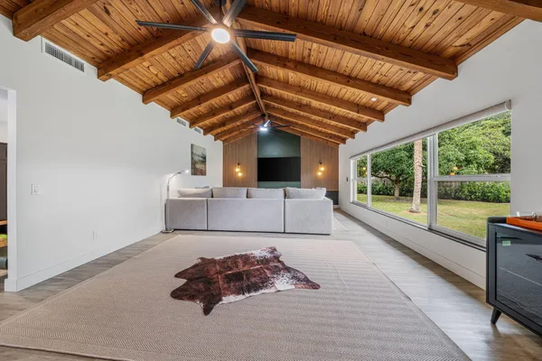 a bed room with a bed and a large window