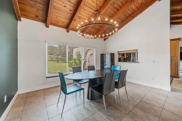 a view of a dining room with furniture and chandelier