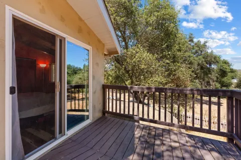 a view of a balcony with wooden floor