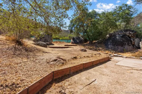a view of a yard with wooden fence