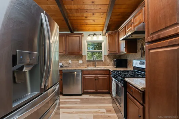 a kitchen with stainless steel appliances granite countertop a stove and a refrigerator