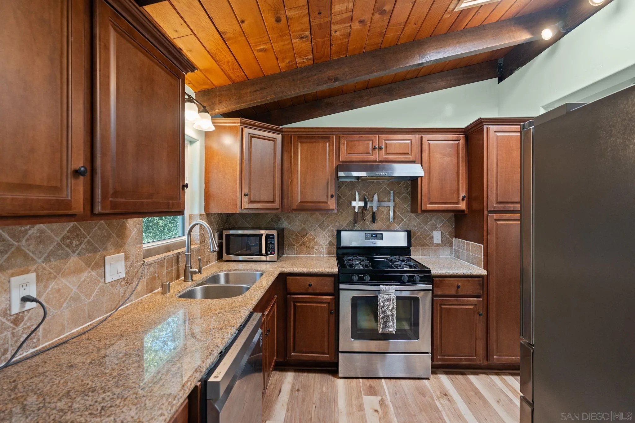 4722 Park Lane Alpine, CA 91901 - Photo 10 of 35 a kitchen with stainless steel appliances granite countertop a stove a sink and a microwave