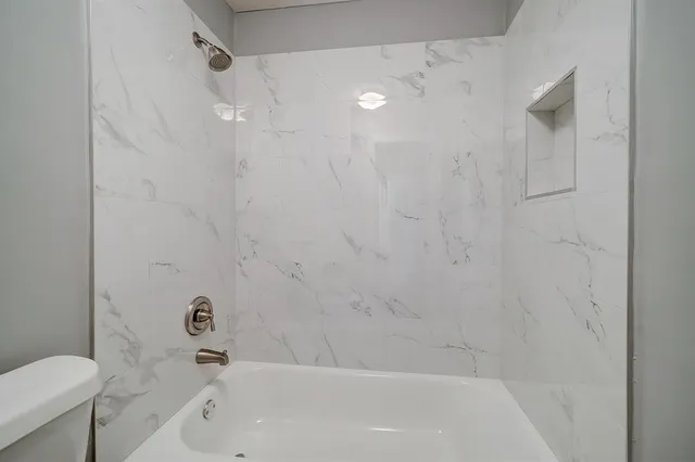 a bathroom with a bathtub and a toilet