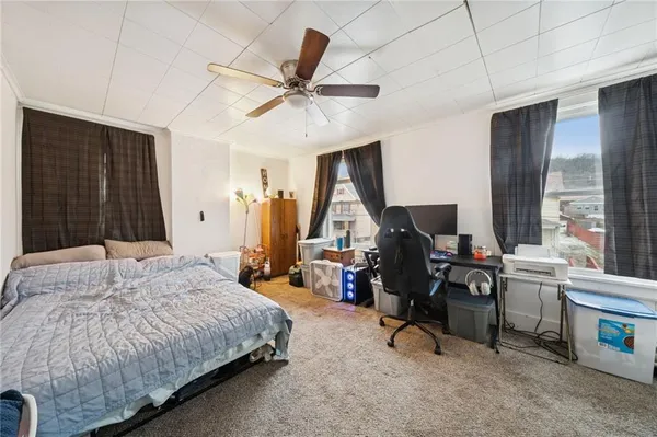 a bedroom with a bed a desk and chair